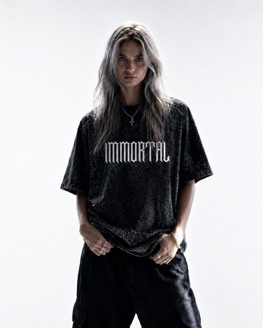 Person wearing a black 'Immortal' t-shirt on a white background