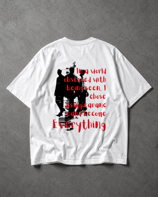 White t-shirt with black and red graphic design on a gray background