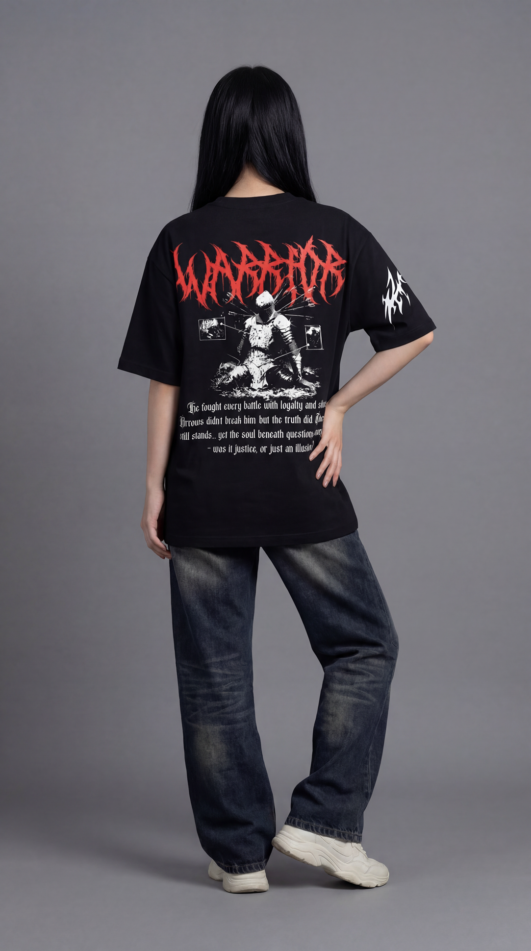 Person wearing a black t-shirt with red and white graphics and text on a gray background