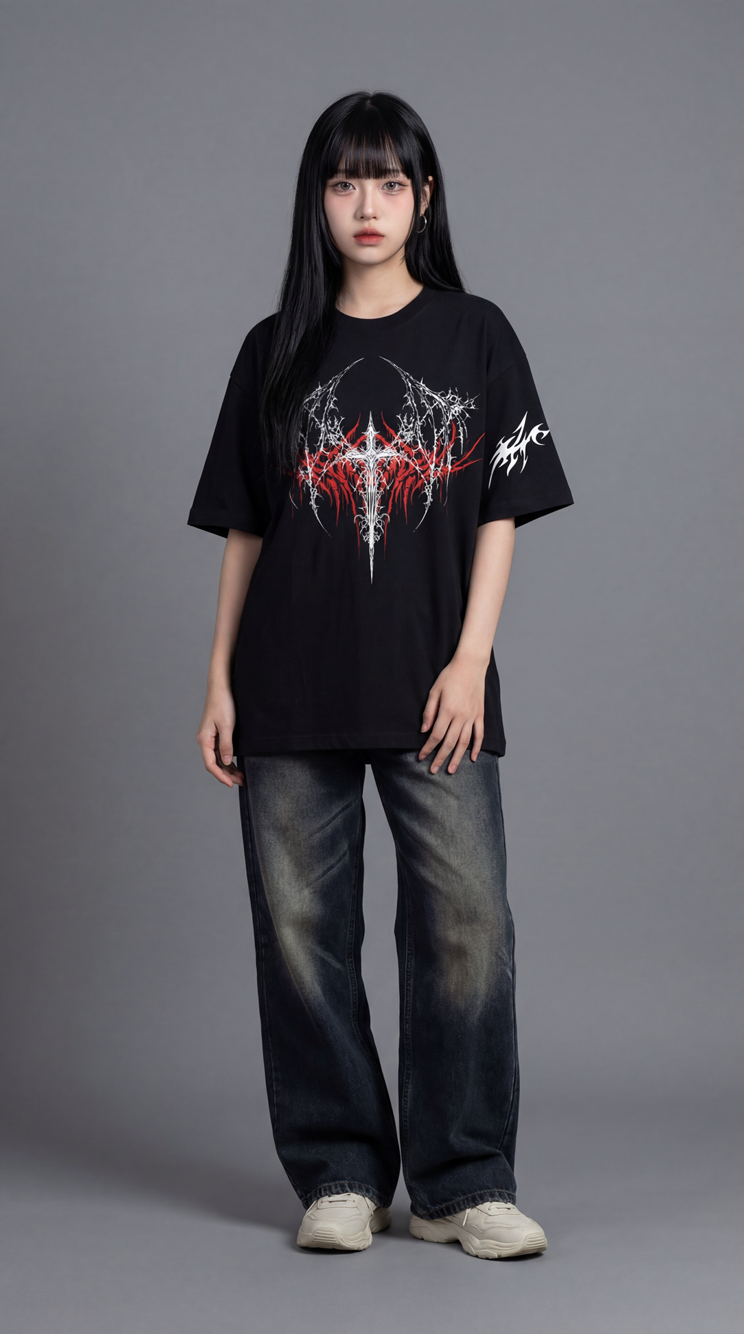 Person wearing a black t-shirt with a graphic design on a gray background