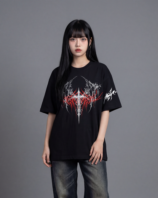 Person wearing a black t-shirt with a graphic design on a gray background