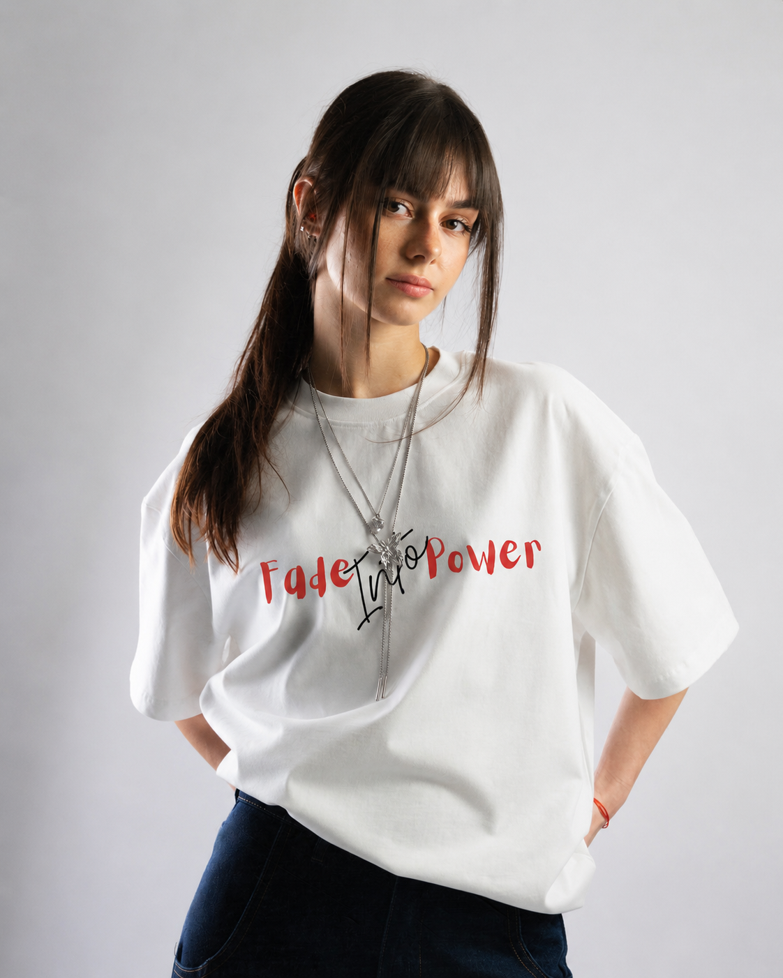 Woman wearing a white t-shirt with text on a plain background
