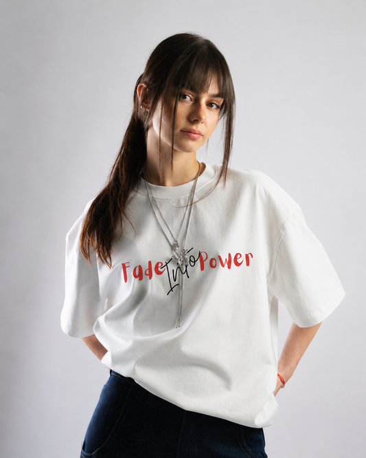 Woman wearing a white t-shirt with text on a plain background