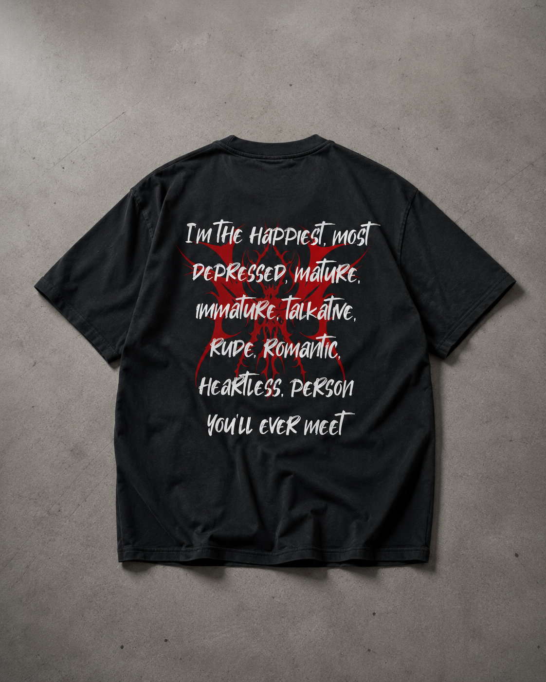 Black t-shirt with white and red text on a gray concrete surface