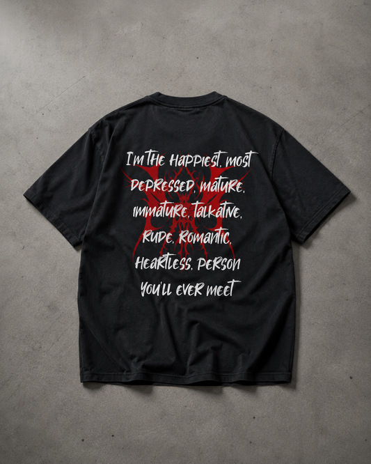 Black t-shirt with white and red text on a gray concrete surface