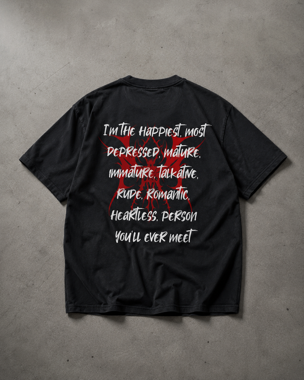Black t-shirt with white and red text on a gray concrete surface
